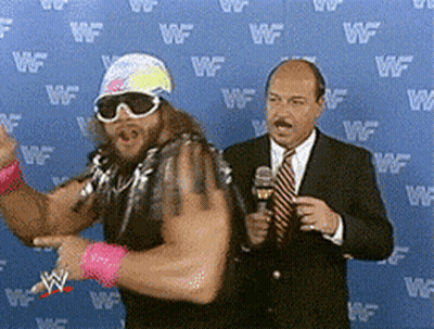 Man In Suit Talking Into Microphone GIF