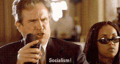 Man In Suit Talking Mic Woman Says Socialism GIF