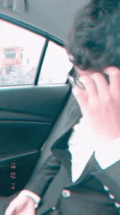 Man In Suit Talking On Cell Phone In Car February 22 GIF