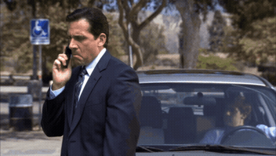 Man In Suit Talking On Cell Phone Near Handicapped Sign GIF