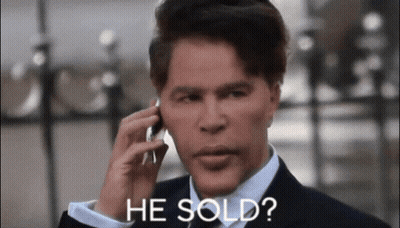 Man in Suit Talking on Cell Phone Saying He Sold