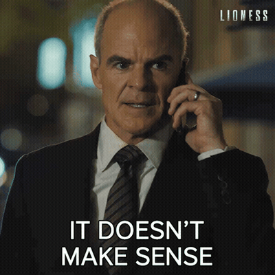 Man In Suit Talking On Cell Phone Saying It Doesn't Make Sense GIF
