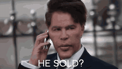 Man in Suit Talking on Cell Phone Says He Sold