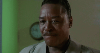 Man In Suit Talking On Cell Phone With Another Man Behind GIF