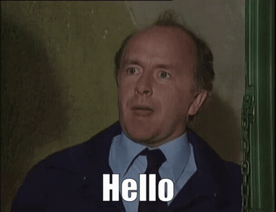 Man In Suit Talking On Phone Saying Hello GIF