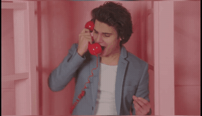 Man In Suit Talking On Red Telephone Saying More GIF