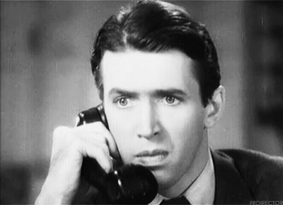 Man in Suit Talking on Telephone