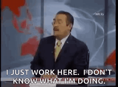 Man In Suit Talking On TV At Desk GIF