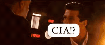 Man In Suit Talking To Another In Dark Room GIF