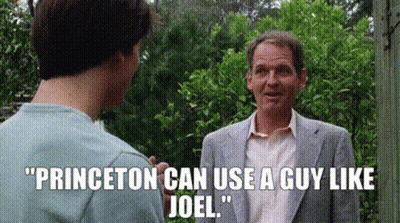 Man In Suit Talking To Another In Garden GIF
