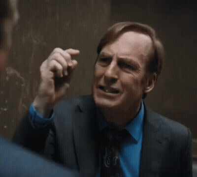 Man In Suit Talking To Another In Hallway GIF