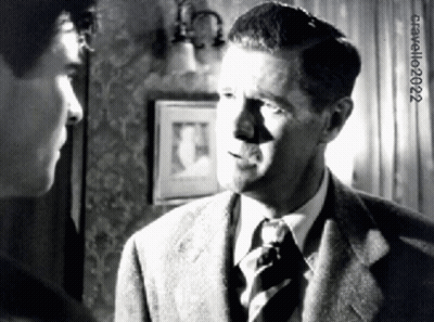 Man in Suit Talking to Another Man