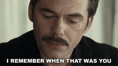 Man In Suit Talking To Another Man At Table GIF