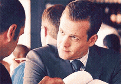 Man In Suit Talking To Another Man Holding Paper GIF