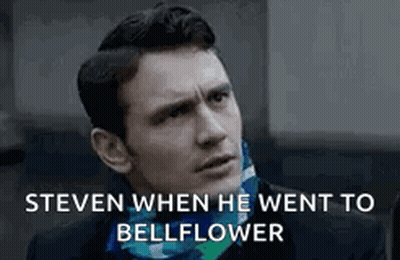 Man In Suit Talking To Another Man In Dark Room GIF