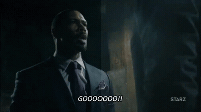 Man In Suit Talking To Another Man In Dark Room GIF