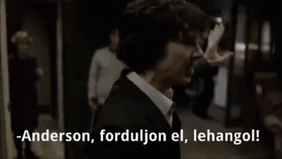 Man In Suit Talking To Another Man In Dark Room GIF