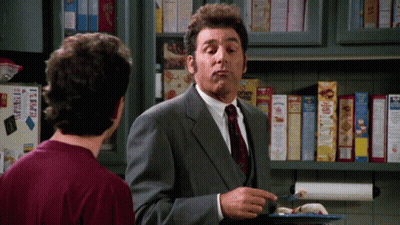 Man In Suit Talking To Another Man In Front Of Cereal Shelf GIF