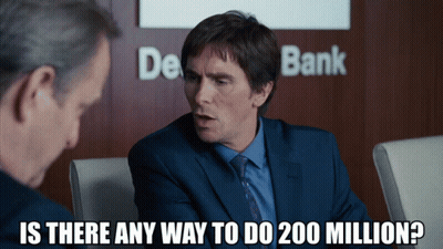 Man In Suit Talking To Another Man In Front Of De Bank Sign GIF