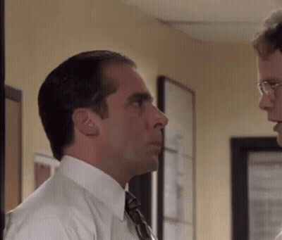 Man In Suit Talking To Another Man In Hallway GIF