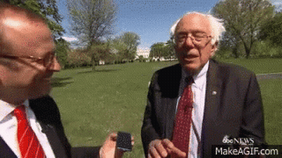 Man In Suit Talking To Another Man In Park GIF