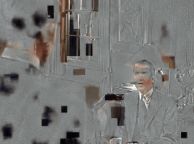 Man In Suit Talking To Another Man On Couch GIF