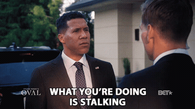 Man In Suit Talking To Another Man Saying What You're Doing Is Stalking GIF