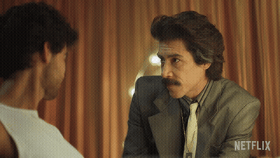 Man In Suit Talking To Another With Netflix Logo GIF