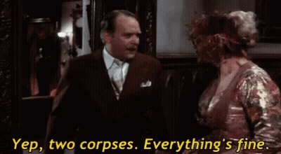 Man In Suit Talking To Blood-Covered Woman In Dress GIF