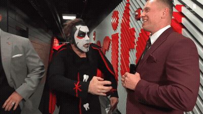 Man In Suit Talking To Costumed Man GIF