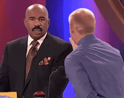Man In Suit Talking To Man In Blue Shirt GIF