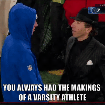 Man In Suit Talking To Man In NFL Hoodie GIF