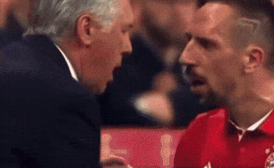 Man In Suit Talking To Man In Red Shirt GIF