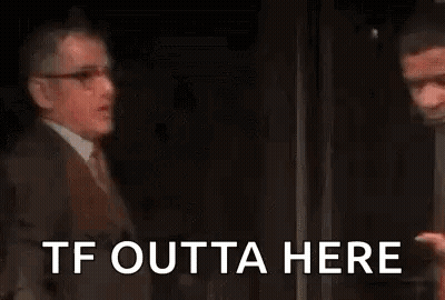 Man In Suit Talking To Man In Red Shirt GIF