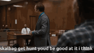 Man In Suit Talking To Man Skalbag Get Hunt GIF