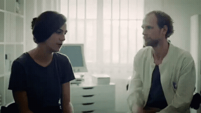 Man In Suit Talking To Older Man In Glasses GIF