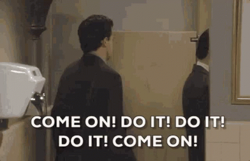 Man In Suit Talking To Reflection In Public Restroom GIF