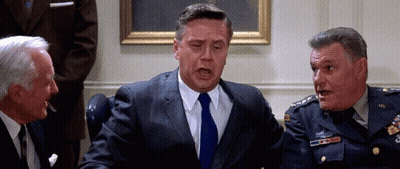 Man In Suit Talking To Two Men GIF