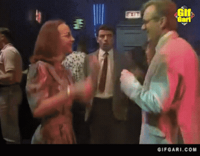 Man In Suit Talking To Woman By Exit Sign GIF