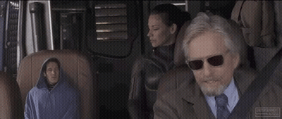 Man In Suit Talking To Woman In Hoodie In Car GIF