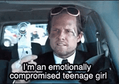 Man In Suit Talking To Woman In Police Station Holding Coffee GIF