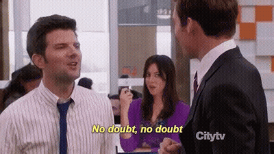 Man In Suit Talking To Woman In Purple GIF