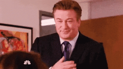 Man In Suit Talking To Woman In Room GIF