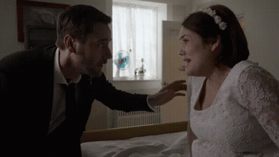 Man In Suit Talking To Woman In White Dress GIF