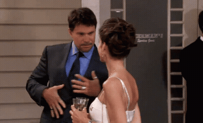 Man In Suit Talking To Woman In White Dress GIF