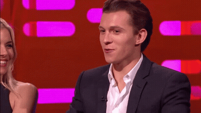 Man In Suit Talking To Woman On Red Background GIF