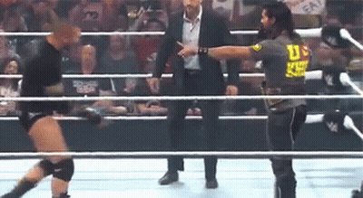 Man In Suit Talking To Wrestler In Ring GIF