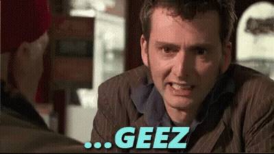 Man In Suit Talking With Geez Above GIF
