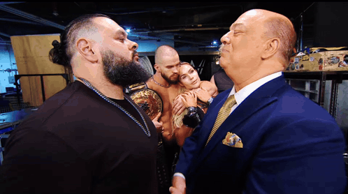 Man in Suit Talks to Man in Bearded Shirt