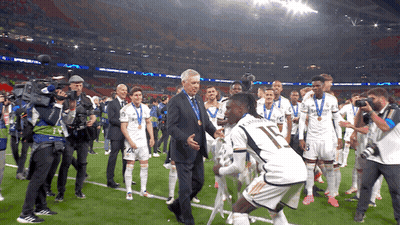 Man In Suit Talks To Soccer Player Number 17 GIF